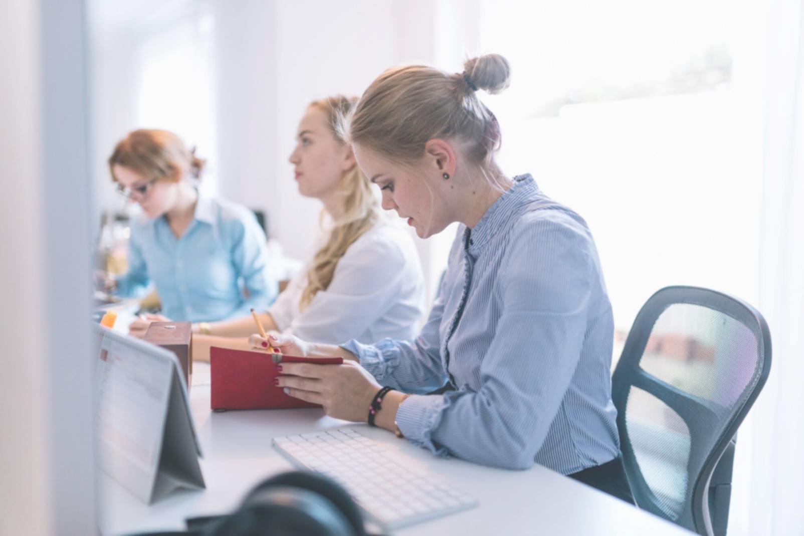 Professional woman presenting financial data to corporate team in modern boardroom
